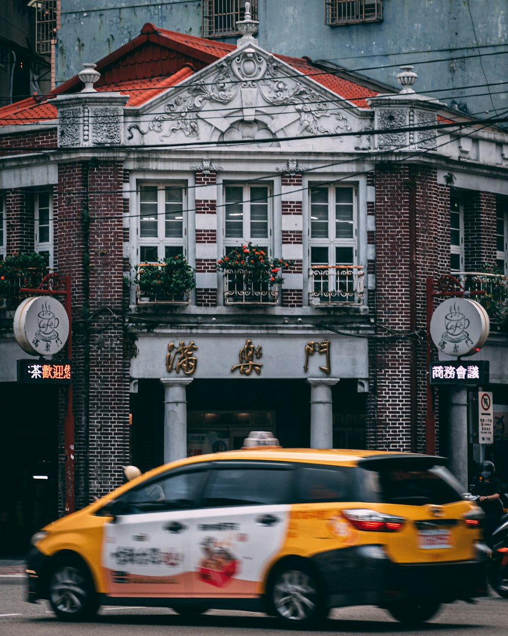 yellow car parked in front of white concrete building during daytime