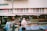 man in white t-shirt standing near food stall