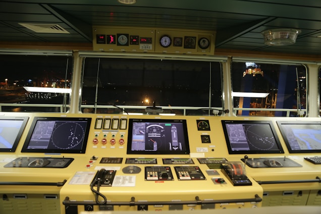 Modern marine engineering control room with digital screens displaying ship stability data.