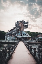 brown dragon statue near body of water during daytime