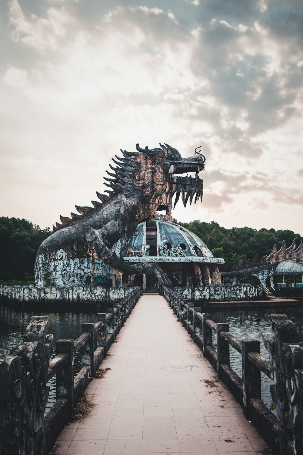 brown dragon statue near body of water during daytime