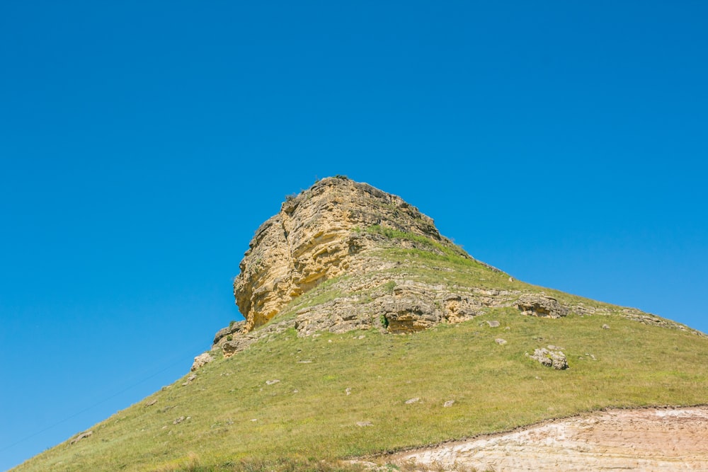 green and brown rock formation under blue sky during daytime