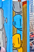 A robot painting a vibrant mural on a city wall, splashes of robotic blue and orange.