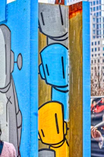 Colorful cartoon illustration of two friendly engineers with tools and playful robots around them.