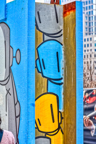 Colorful cartoon illustration of two friendly engineers with tools and playful robots around them.