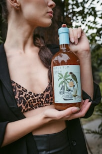 woman holding white labeled bottle