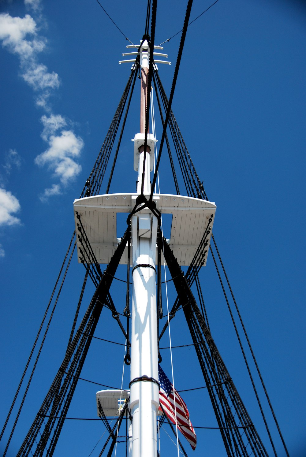 white and black sail boat under blue sky during daytime