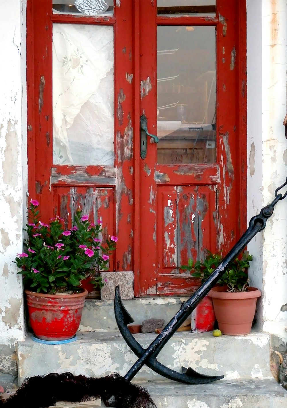 黒い金属製の取っ手が付いた赤い木製のドア