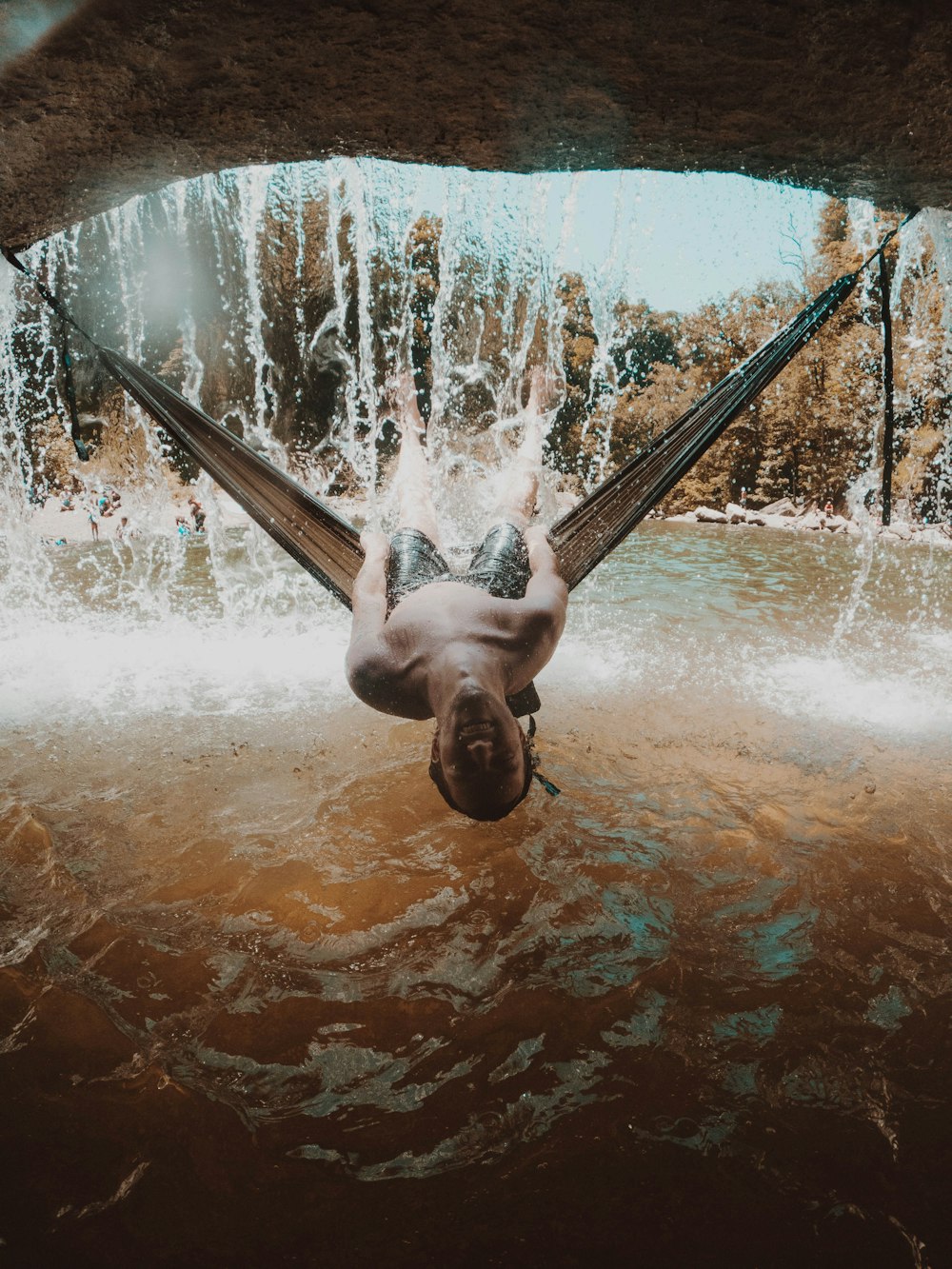 man in water fountain during daytime