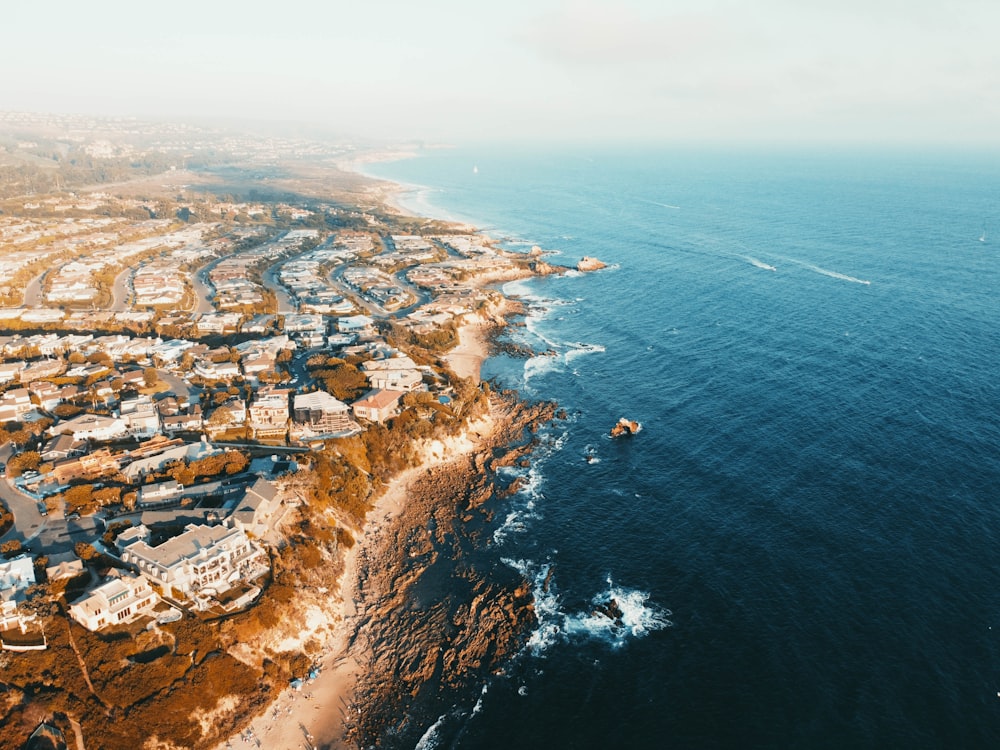 aerial view of city near body of water during daytime