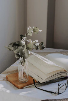 A cozy study nook with an open book, a steaming cup of tea, and soft natural light.