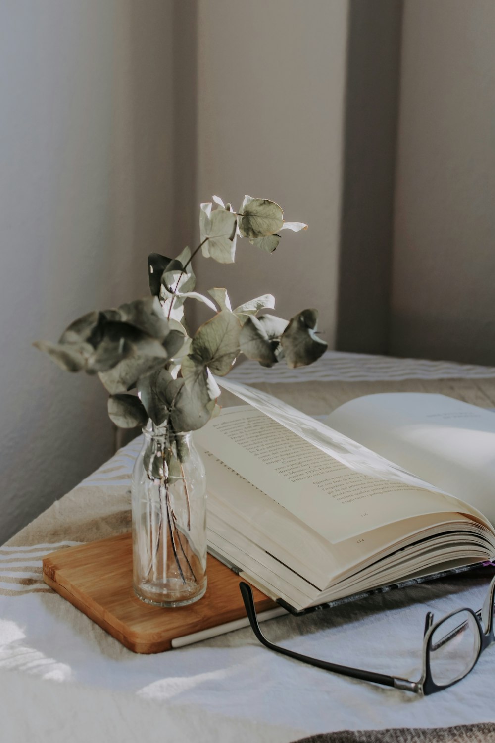 white flowers in clear glass vase on brown wooden table