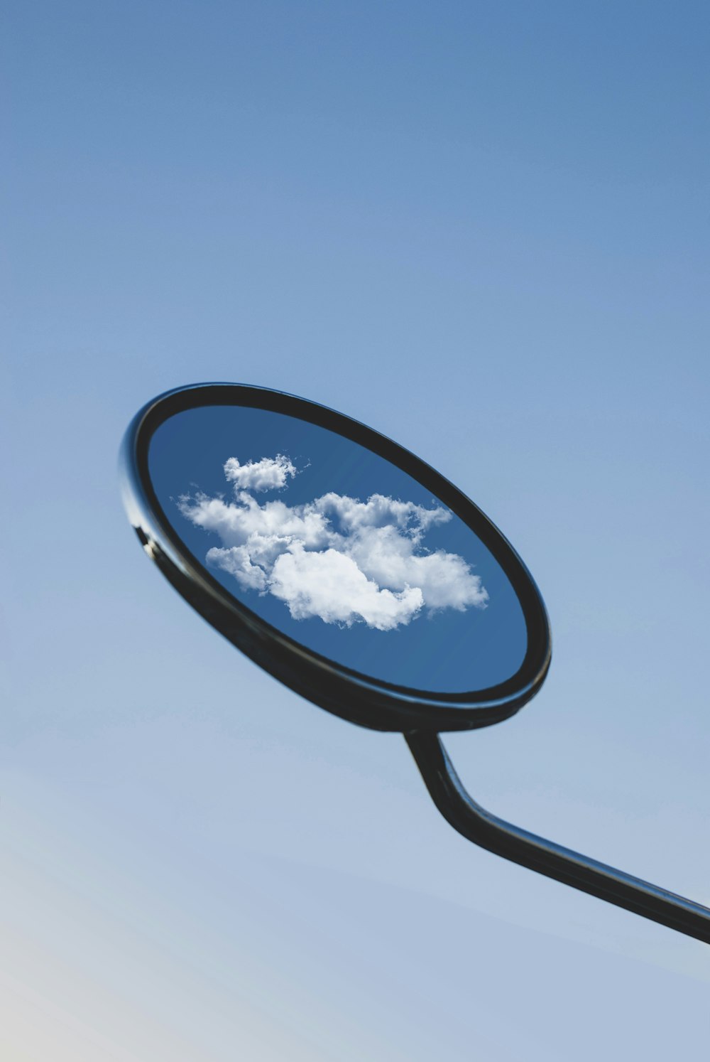 black framed magnifying glass under blue sky during daytime