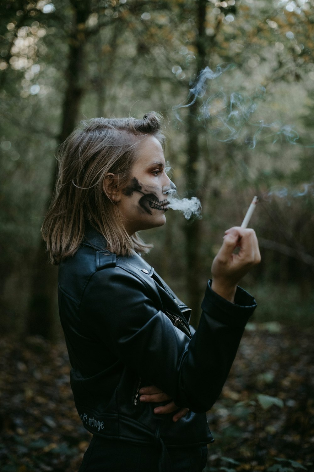 woman in black jacket smoking
