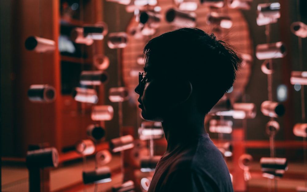 a man standing in front of a display of glass objects