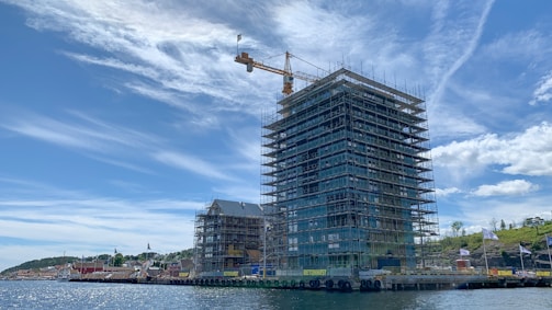 gray concrete building near body of water during daytime