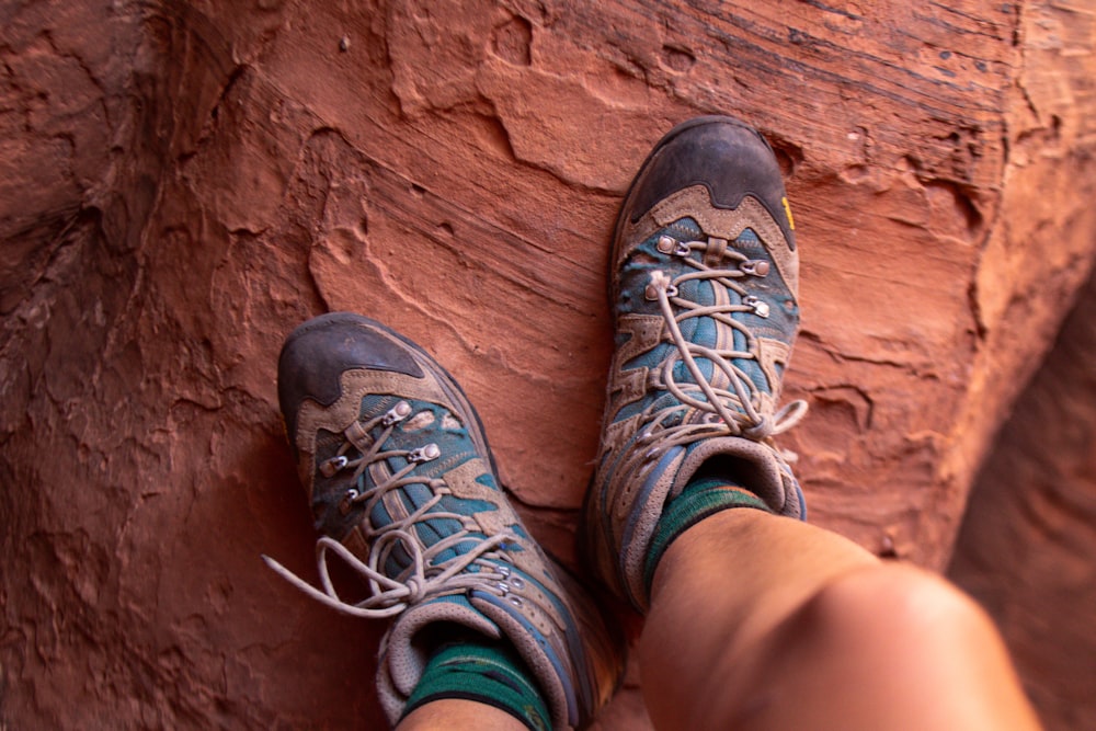 person wearing black and gray hiking shoes