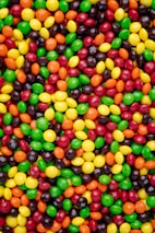 A close-up of vibrant candies in various shapes and colors.
