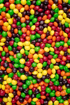 A close-up of vibrant candies in various shapes and colors.