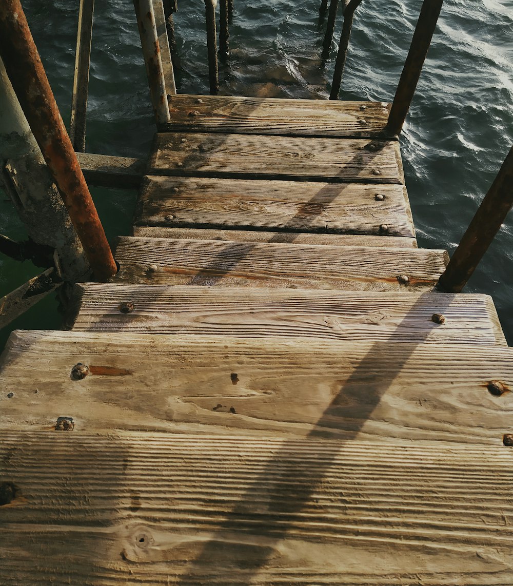 brown wooden dock over body of water during daytime