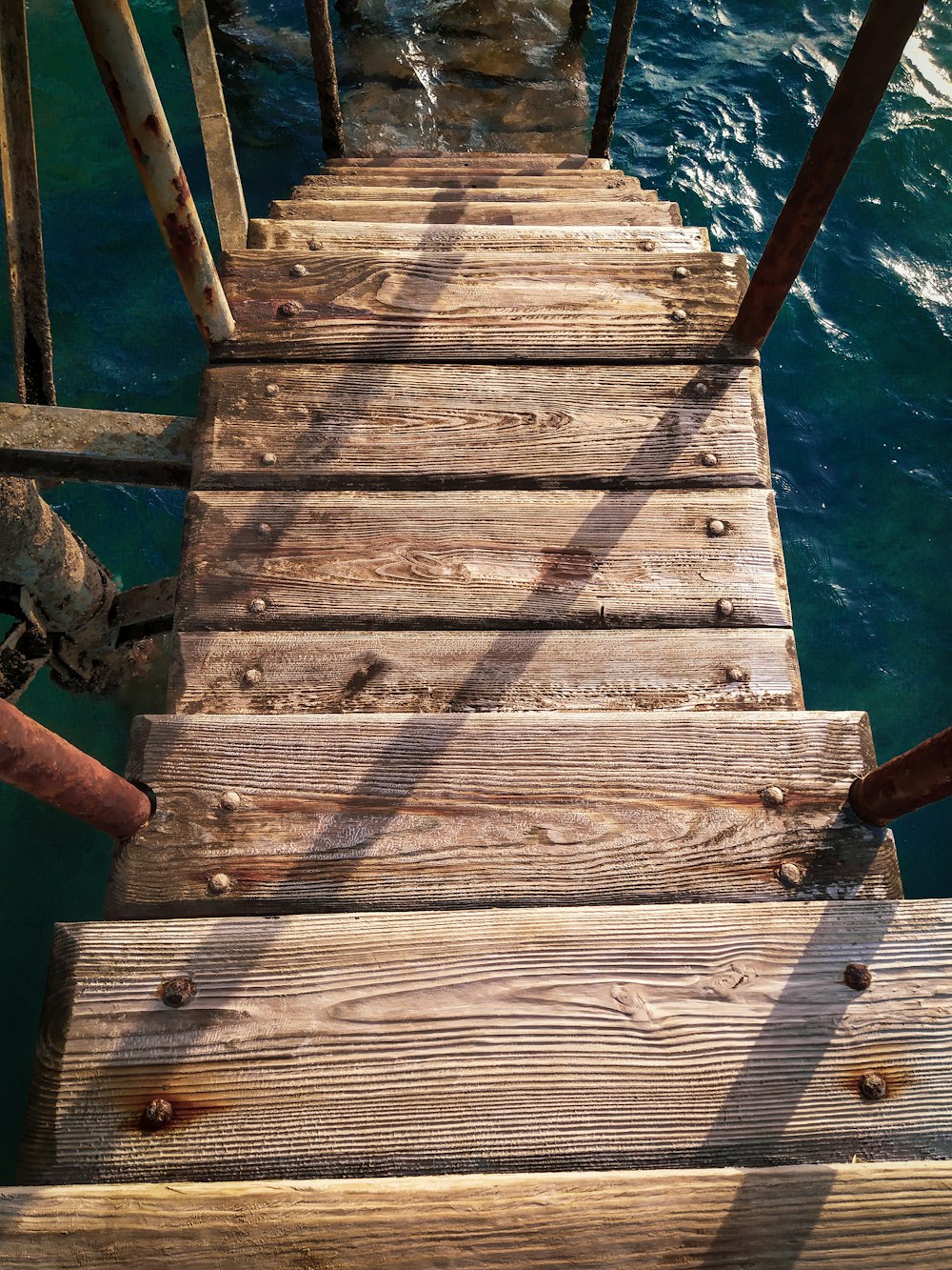 brown wooden dock over blue water