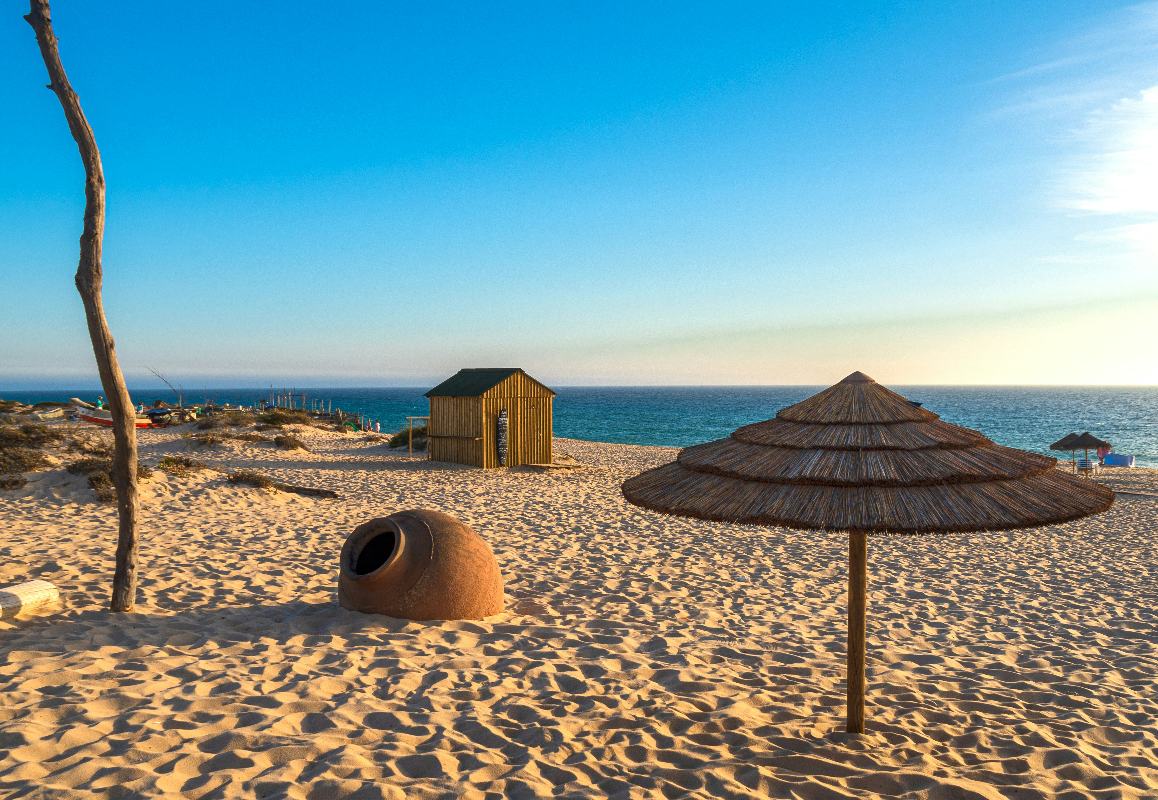 brown wooden house on beach during daytime