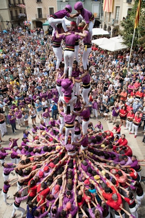 people in pink and purple dress dancing on street during daytime