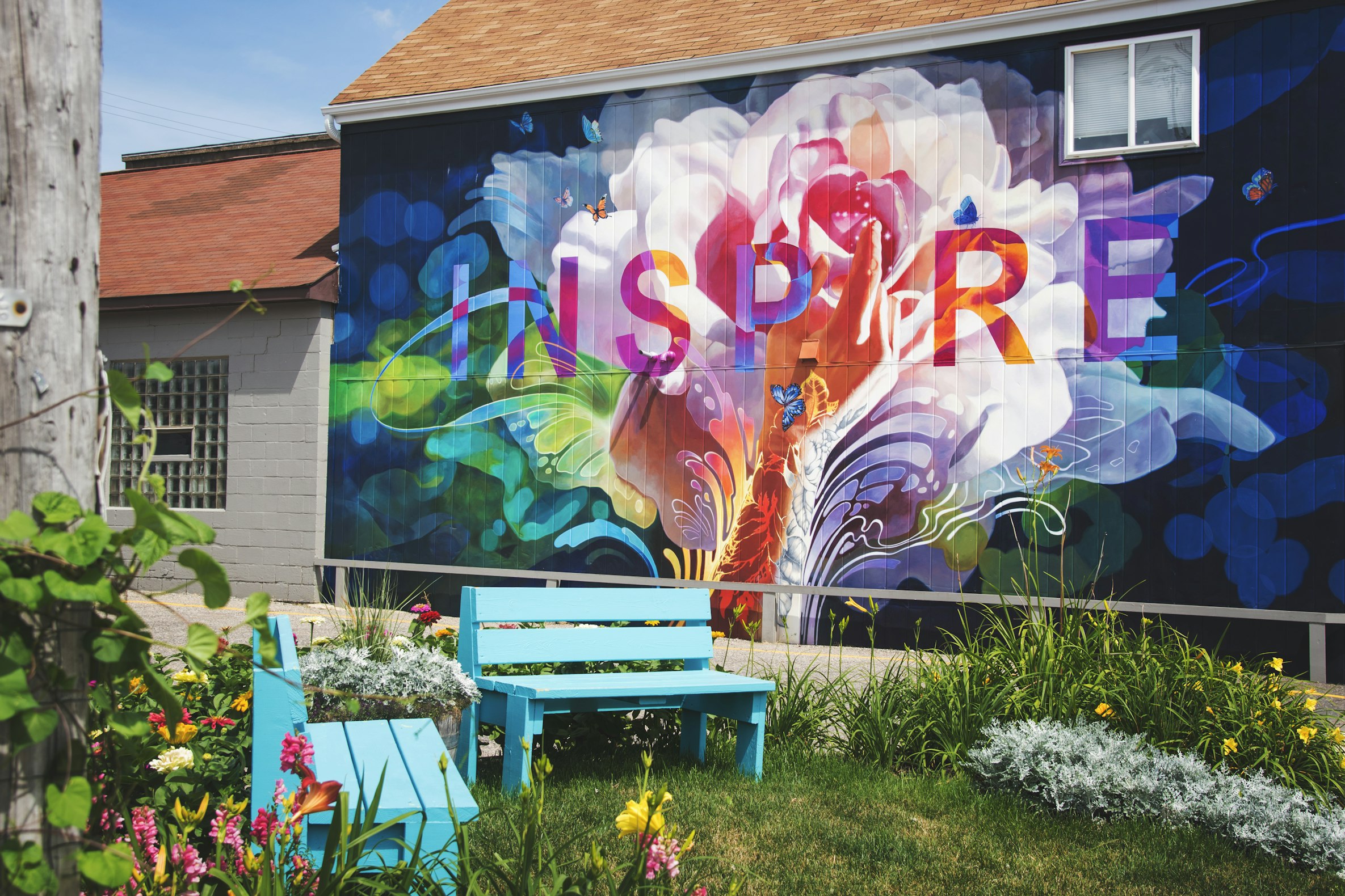 Mural of the word Inspire with colorful hexagonal shapes, photographed by Gary Meulemans