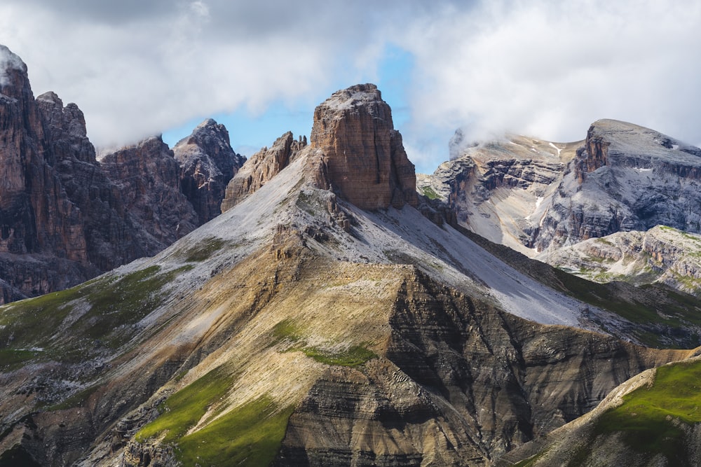 brown rocky mountain under white clouds during daytime