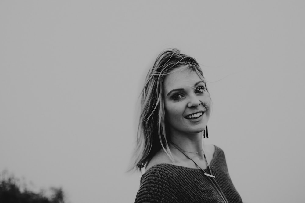 grayscale photo of woman in black knit shirt