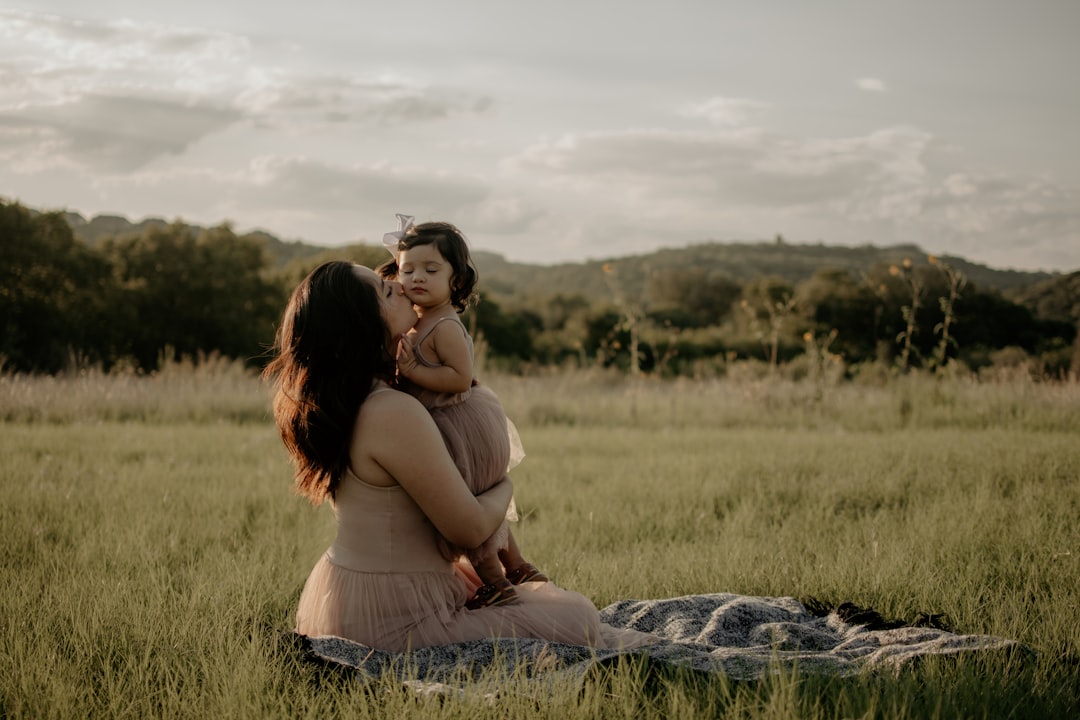 woman in brown tank top sitting on green grass field during daytime