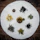 Close-up of colorful tea leaves and herbs arranged artistically on a wooden table.