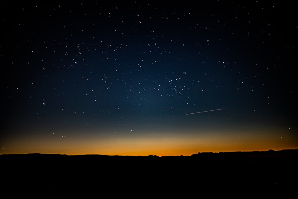 silhouette of mountain during night time