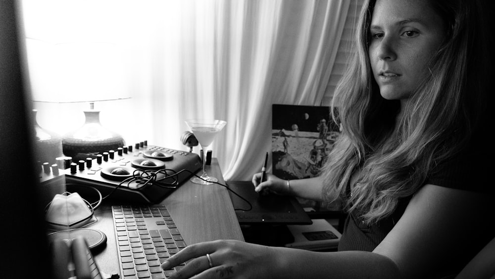 grayscale photo of woman using computer