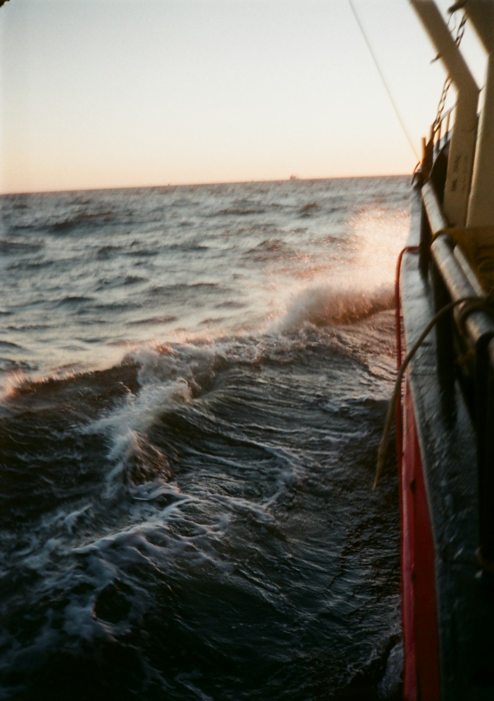 brown wooden boat on sea during daytime