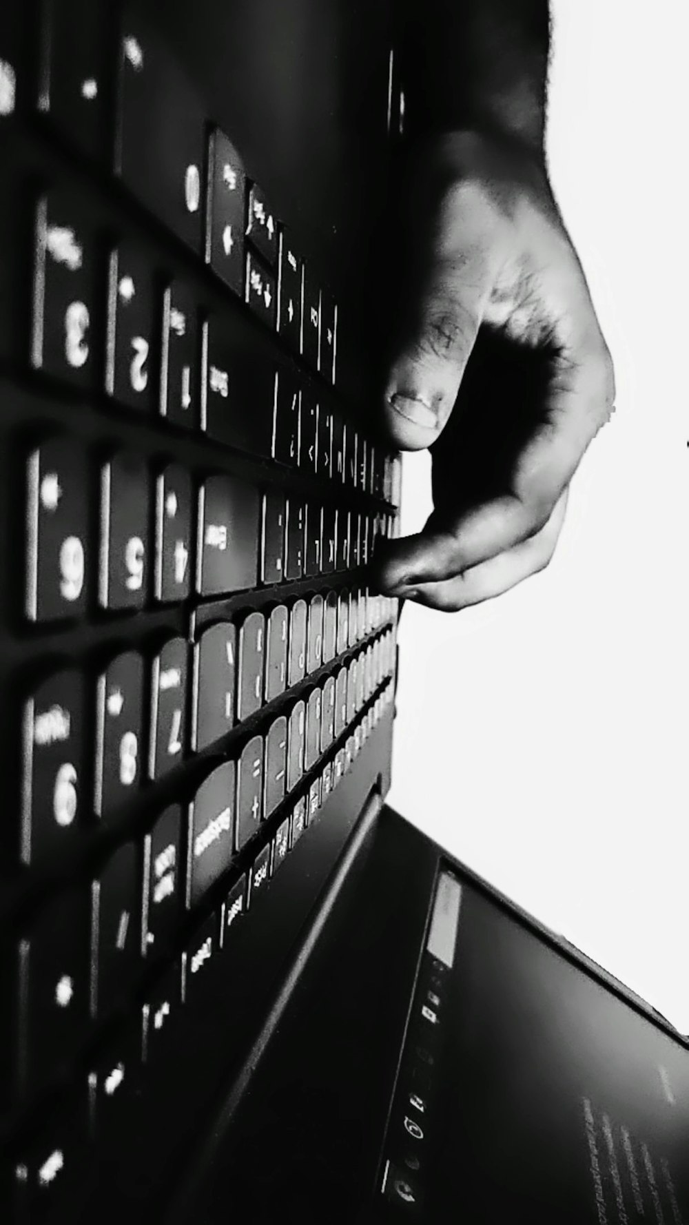 persons hand on black computer keyboard