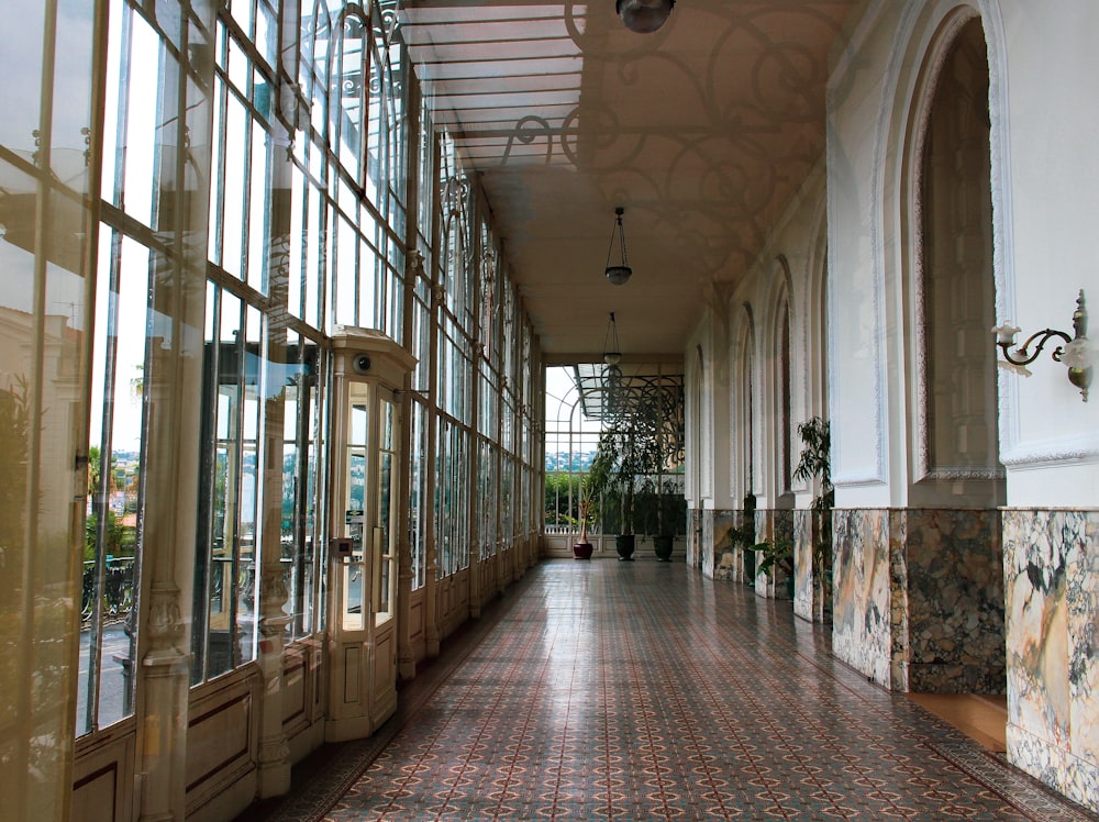 brown and white hallway with glass windows