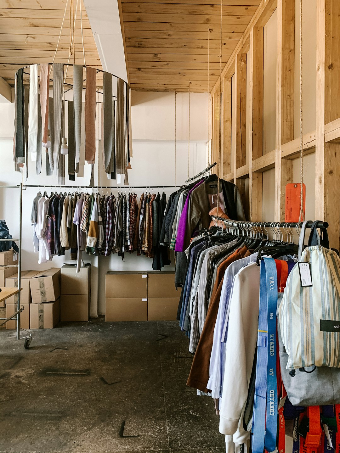 clothes hanged on white wooden cabinet