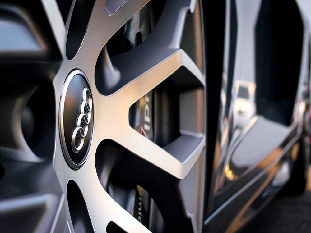 silver mercedes benz emblem on black car wheel