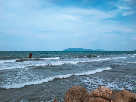 brown rock formation on sea during daytime in Jayapura Indonesia