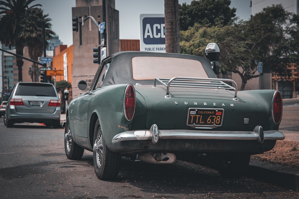 white classic car parked on sidewalk during daytime