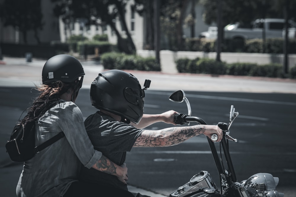 man in black helmet riding on motorcycle during daytime