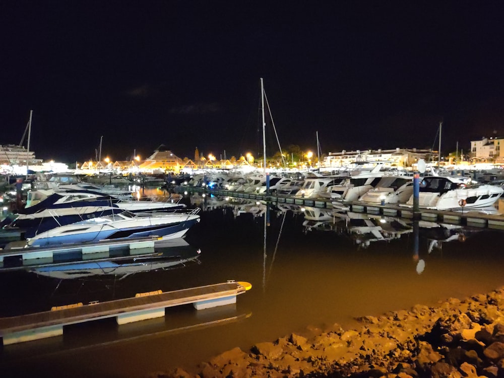 white and black boats on sea during night time