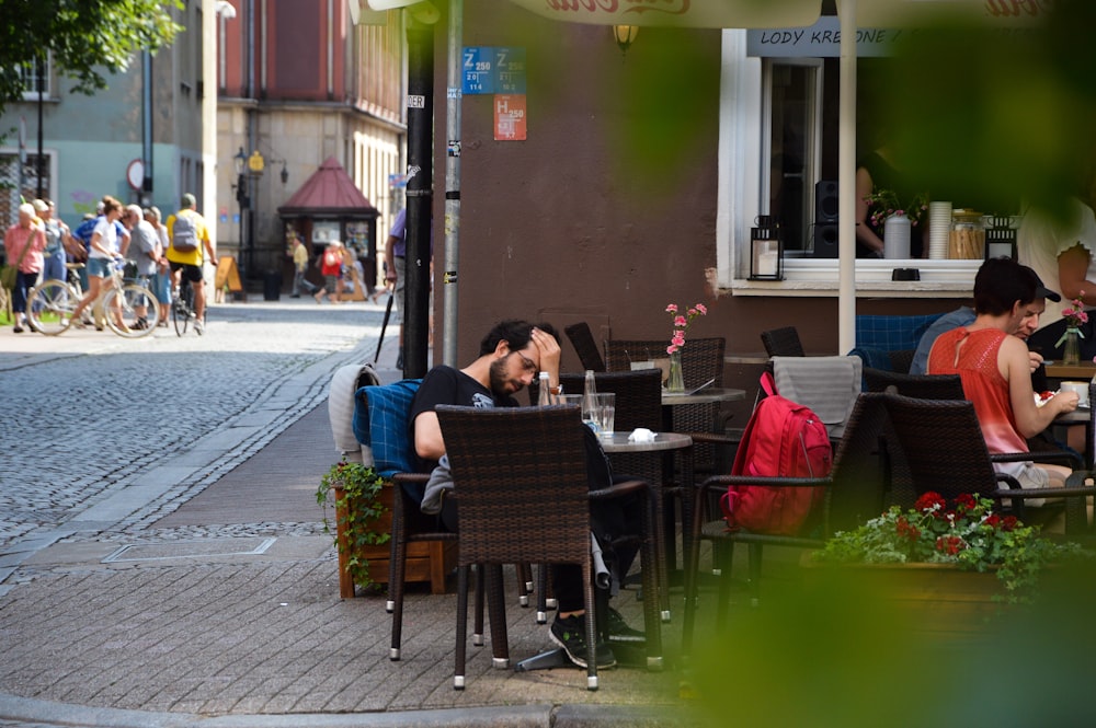 man and woman sitting on chair in front of table