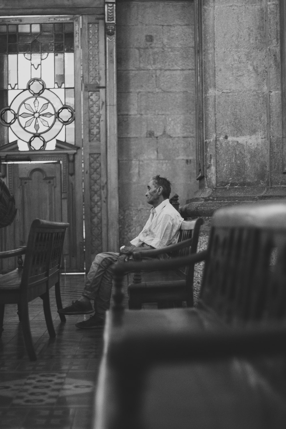 man in white dress shirt sitting on chair