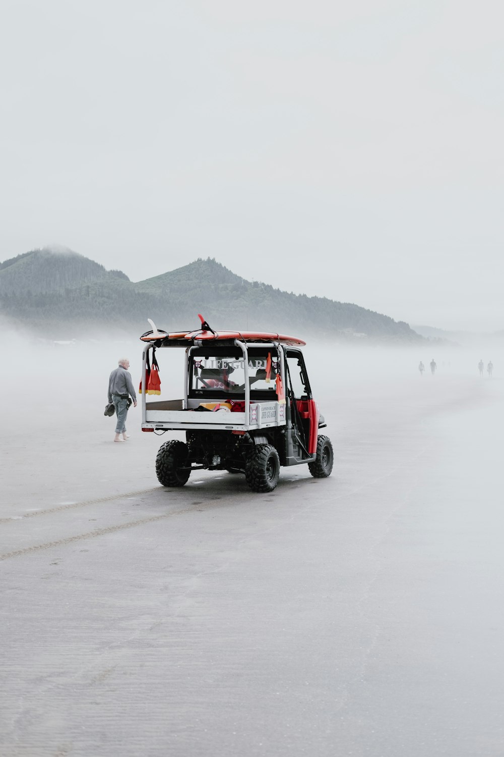 red and black jeep wrangler on snow covered field during daytime