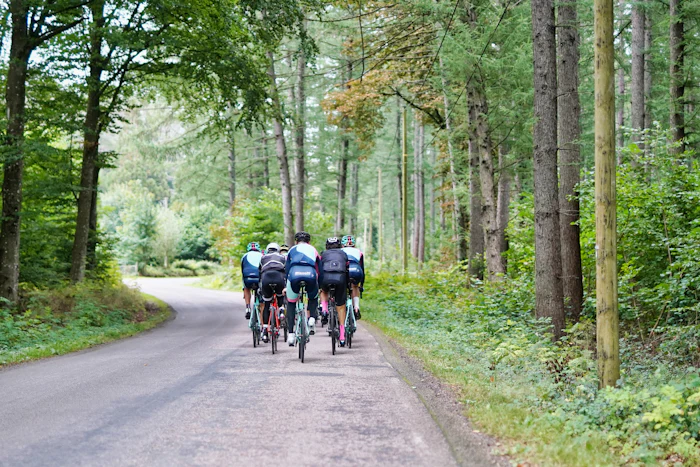 A group ride strung out along the road