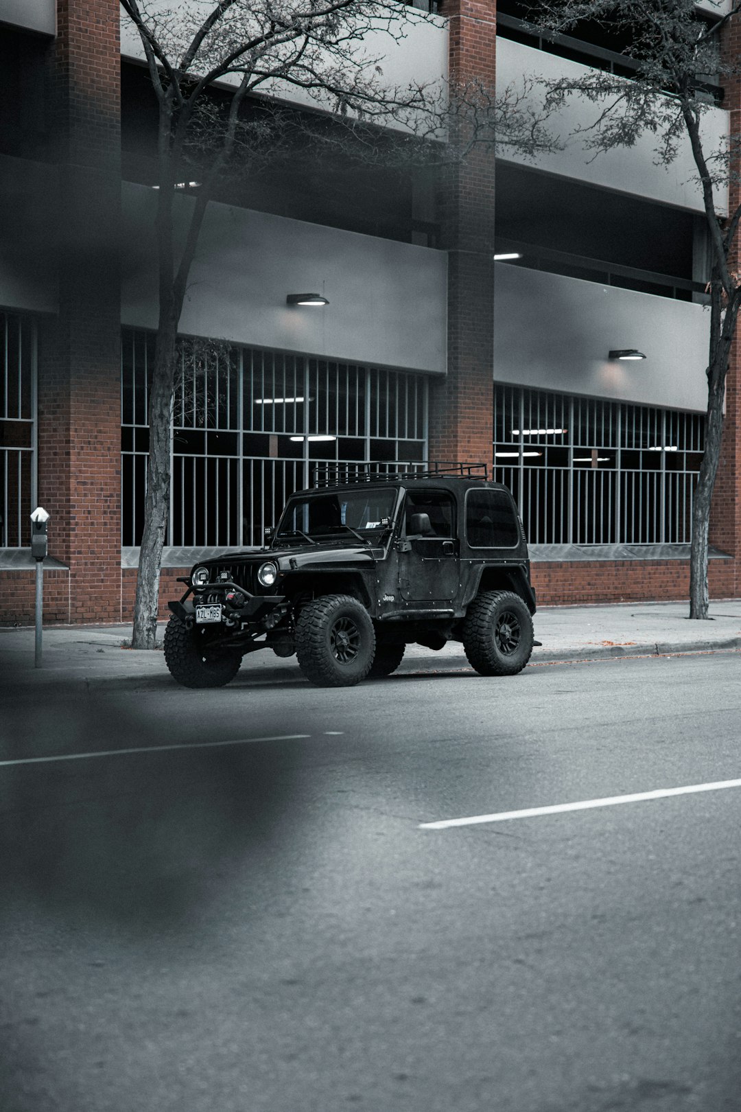 black jeep wrangler parked in front of building