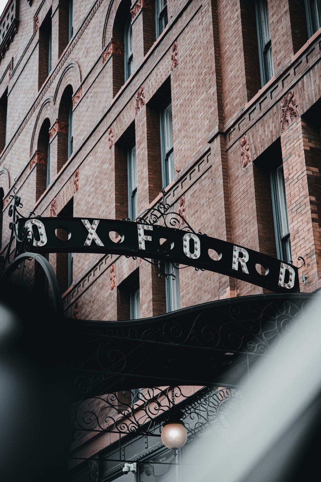 black metal fence near brown concrete building during daytime