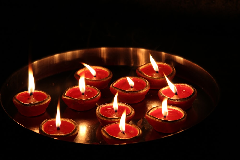 red candles on brown round plate